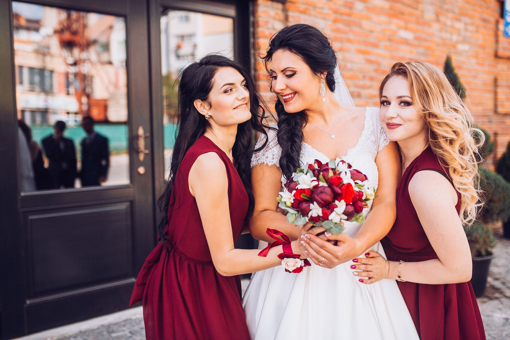 Laughing bride and bridesmaids tell funny stories
